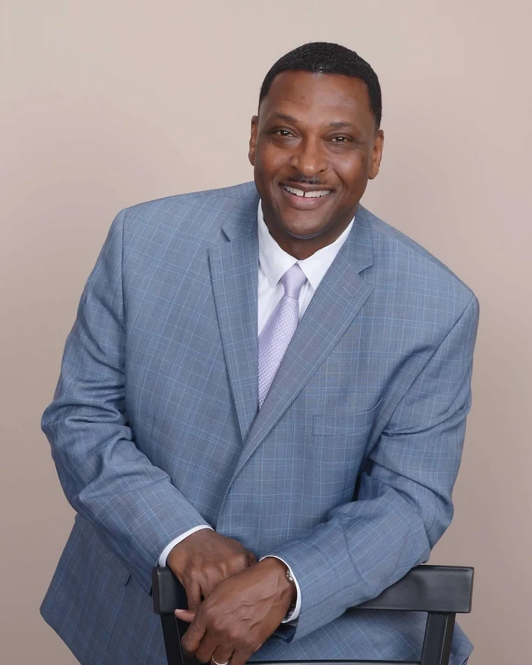Supplied professional portrait in a light blue suit